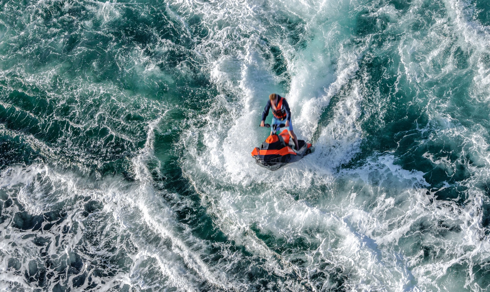 Aerial view of jet skis riding. Whirlpools of the maelstrom of Saltstraumen, Nordland , Norway.