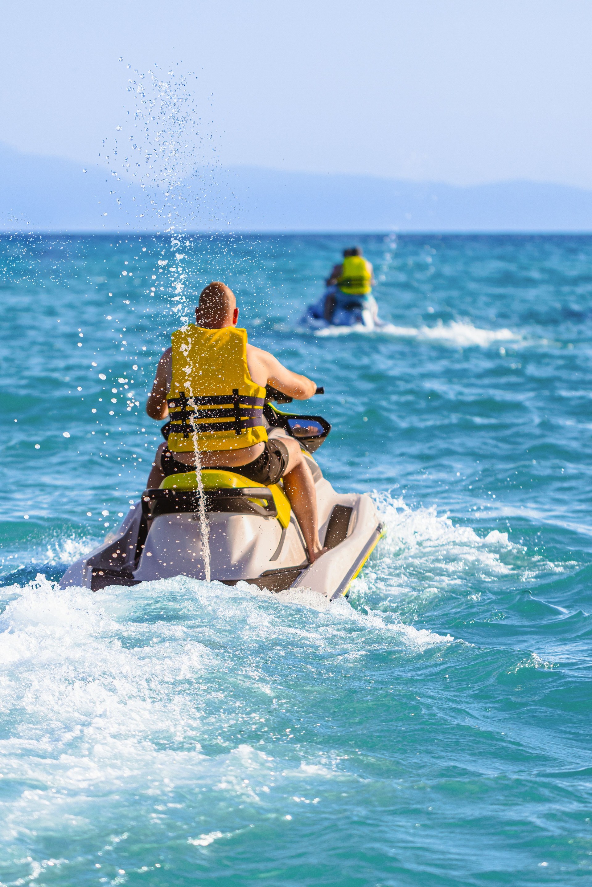 Unrecognizable Caucasian man riding an jet ski, during his vacation