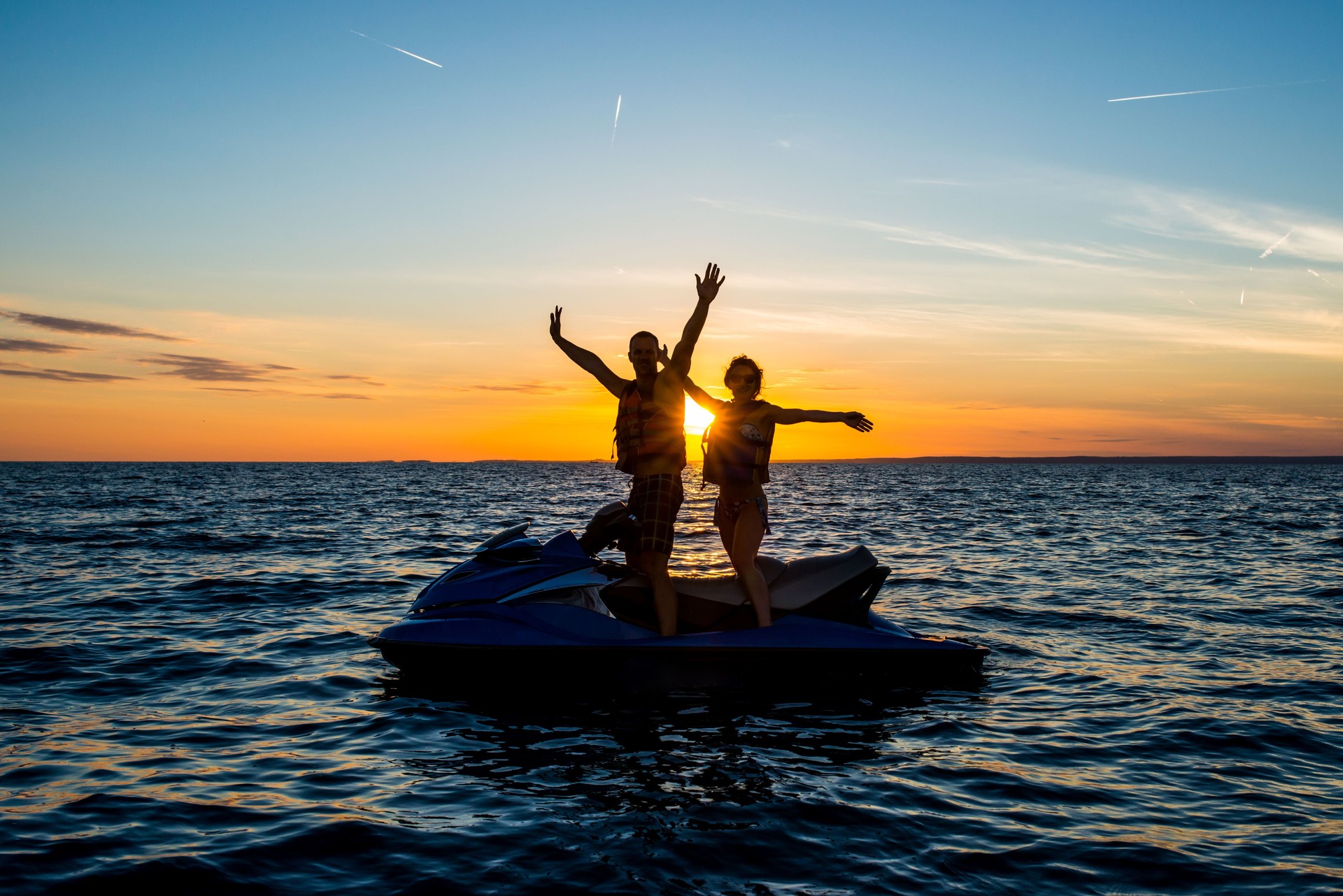Waving On A Jet Boat At Sunset